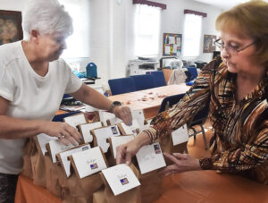 Mon County CEOS members pack food donations for delivery